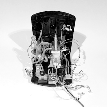 a disassembled automated coffee machine